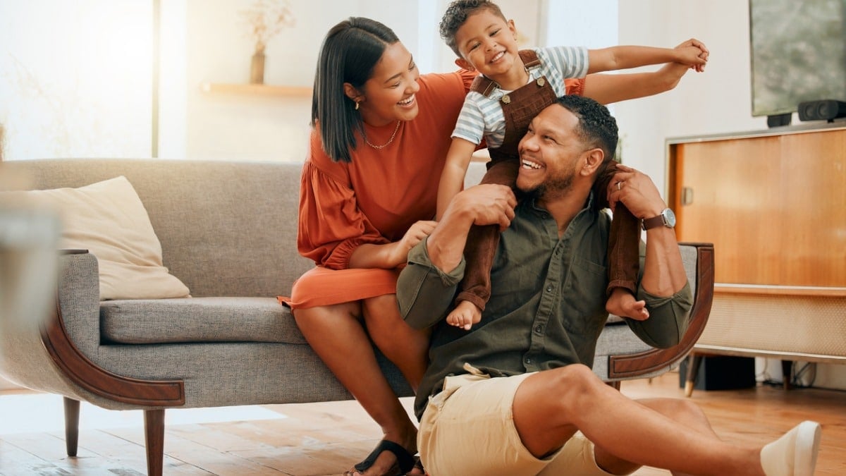 family of three relaxing and playing