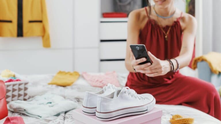 woman decluttering closet taking picture.