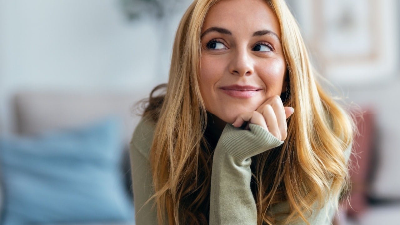 woman thinking and smiling.